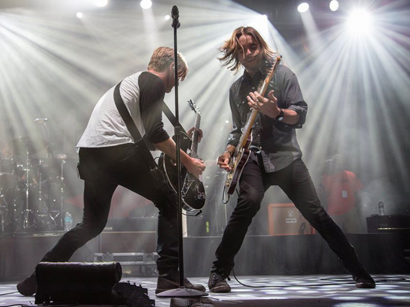 The Foreman brothers rock out on guitars.